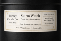 Torrey Candle Co. candle with label detailing product information on a black background